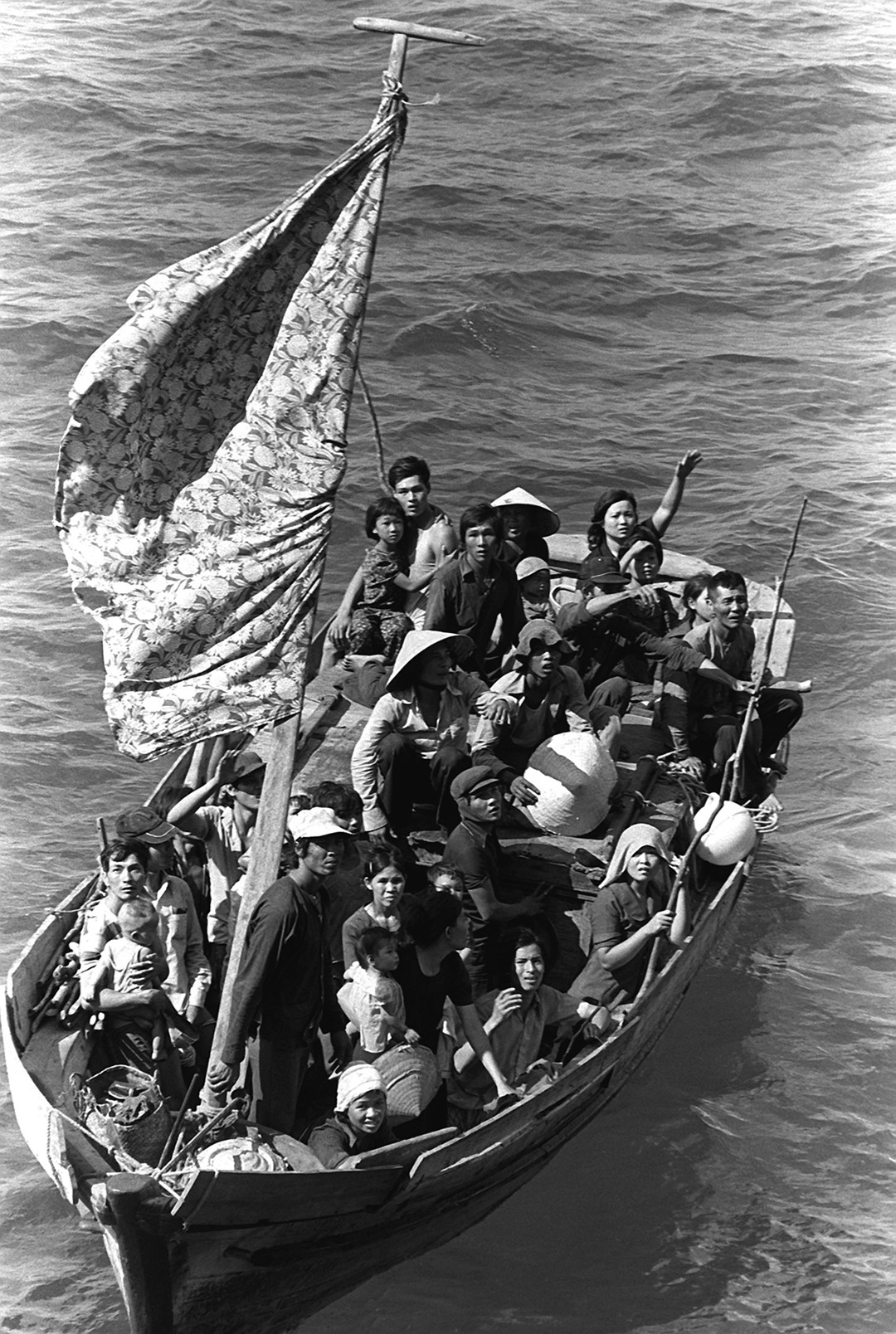 Vietnamese Boat PeopleUnknown 1984More than two million “Vietnamese Boat People” fled their homeland between 1975 and 1995, seeking asylum in neighboring countries and leading to a humanitarian crisis that ended with more than half of the refugees being resettled in the United States. This photograph shows thirty-five refugees awaiting rescue by the USS Blue Ridge. After spending eight days at sea, the thirty-five foot fishing boat was spotted three hundred fifty miles northeast of Cam Ranh Bay, Vietnam